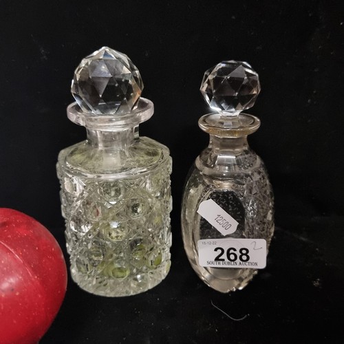 268 - A pair of antique cut crystal perfumed stoppered bottles. Facet cut with original stoppers.