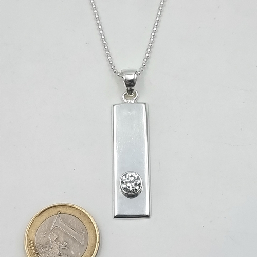 867 - A stunning sterling silver necklace consisting of a silver dog pendant set with a 1 carat white mois... 