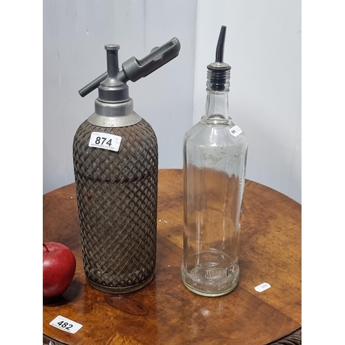 874 - Two branded bar bottles including an antique 'Sparklets' soda siphon. A very heavy example with stee... 