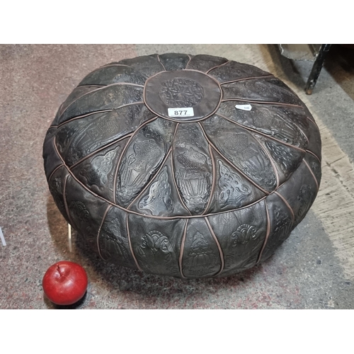 877 - A Moroccan leather footstool with panels featuring abstract debossed patterns. The cover is removabl... 