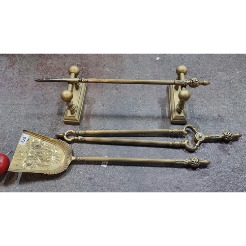 879 - A heavy quality Victorianbrass fireplace companion set comprising of a poker, a shovel and tongs. On... 