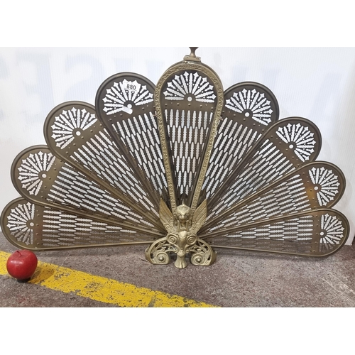 880 - A striking brass peacock folding fire screen with foldable pierced panels and winged lion figure to ... 