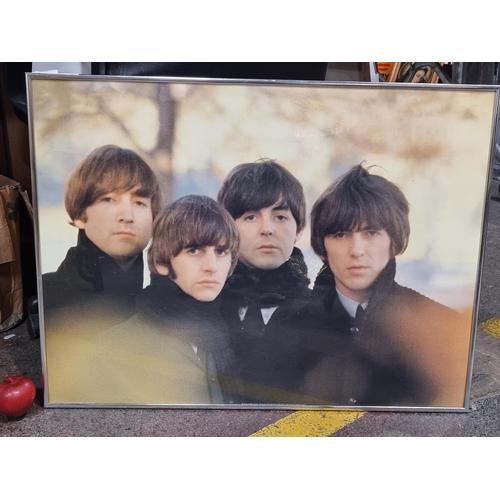 882 - A large print of a photograph depicting the members from the iconic band 'The Beatles'. Housed in a ... 