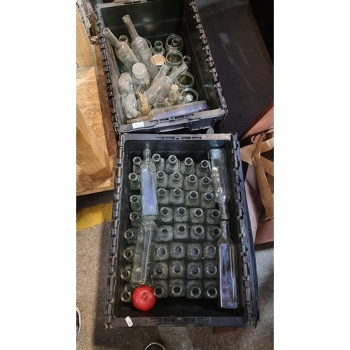 913 - Two crates comprising of various glass bottles and jars. Ideal for culinary use or decoration.