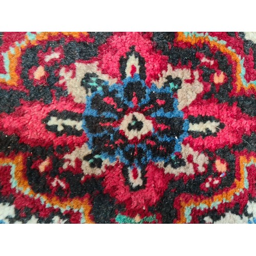 754 - Star lot : A beautiful hand knotted wool rug, in deep shades of red, green and blue. L307cm x W208cm... 
