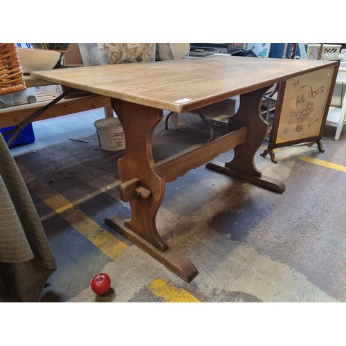 467 - A refectory oak table in the Old Charm series by 'Wood Bros' furniture. Branded to base with brass b... 