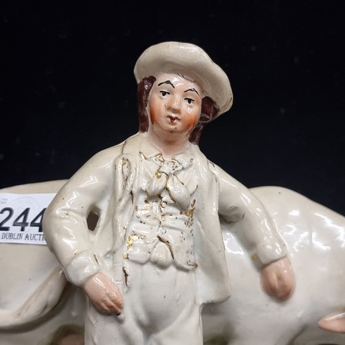 244 - A mid 19th century Staffordshire flatback figure  of A charming porcelain white cow accompanied by a... 