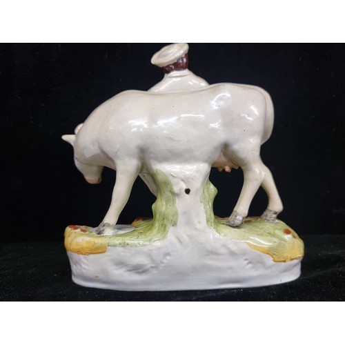 244 - A mid 19th century Staffordshire flatback figure  of A charming porcelain white cow accompanied by a... 