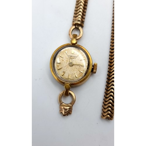 846 - A ladies vintage Longines Swiss made watch with a 9ct gold broken strap, Strap is hallmarked 375, st... 