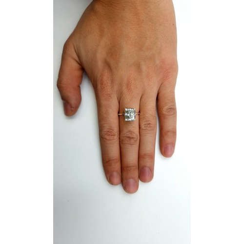 863 - A sparkling emerald cut white 4 carat moissanite solitaire ring set in a sterling silver band. ring ... 