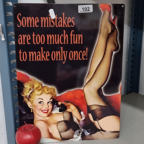 102 - A metal wall sign featuring a classic pin up bombshell and text reading 