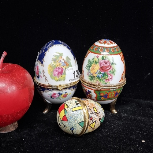 120 - A set of three wonderful decorative egg pill boxes, including two lovely porcelain examples, along w... 