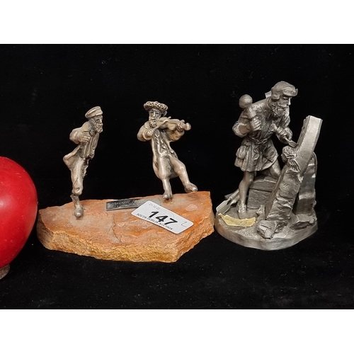 147 - Two pewter figures including a stone mason by the Franklin Mint and a figure group of a fiddler play... 