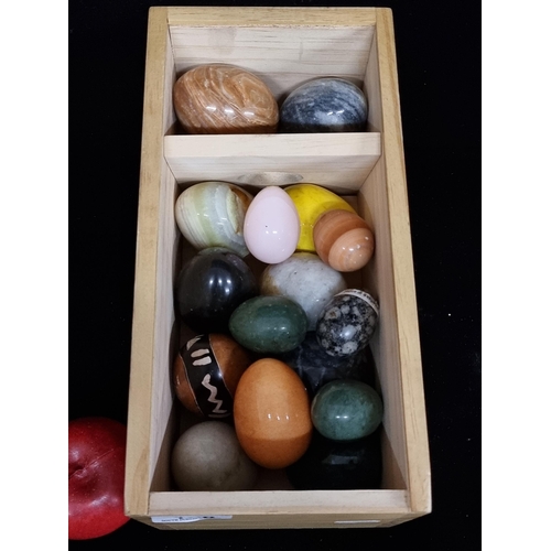 158 - A large collection of marble and crystal eggs including rose quartz, onyx and snowflake granite and ... 