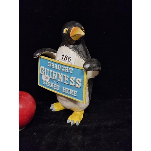 186 - A figure of a penguin holding a sign reading 