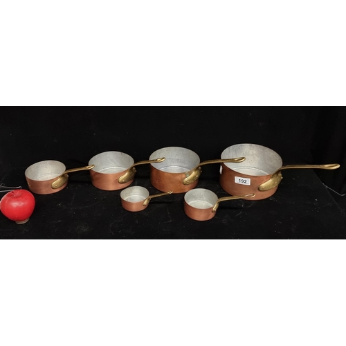 192 - A set of antique six graduated copper saucepans.