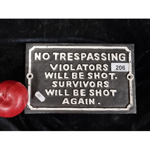 206 - A cast metal wall plaque in a black and white finish. Featuring cautionary text.