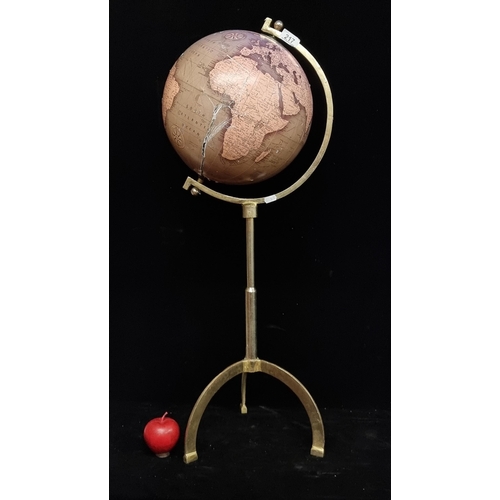 217 - A stylish globe on a heavy brass tripod base. H90cm