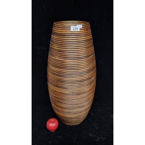 219 - A tall wicker umbrella stand in a barrel shape. H62cm.