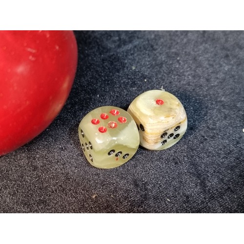 172 - A beautiful pair of carved onyx dice, with gorgeous marbling through the stone and a band of Celtic ... 