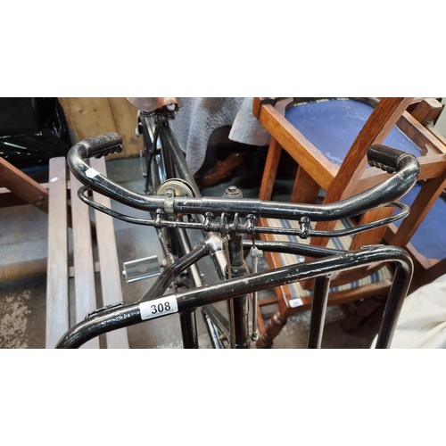 308 - Star lot : A super antique display bicycle with a prop-up frame for a basket, a bell and a leather B... 