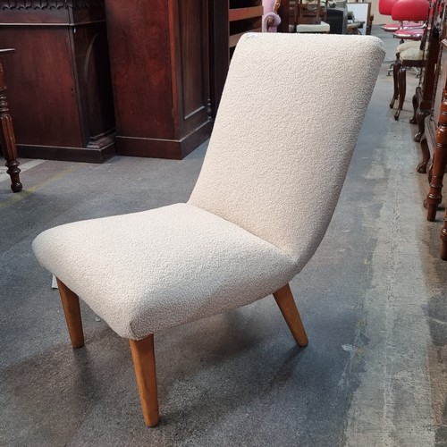 356 - A pair of Mid Century Modern lounge chairs. Upholstered in a cream, bouclé fabric. In lovely clean c... 