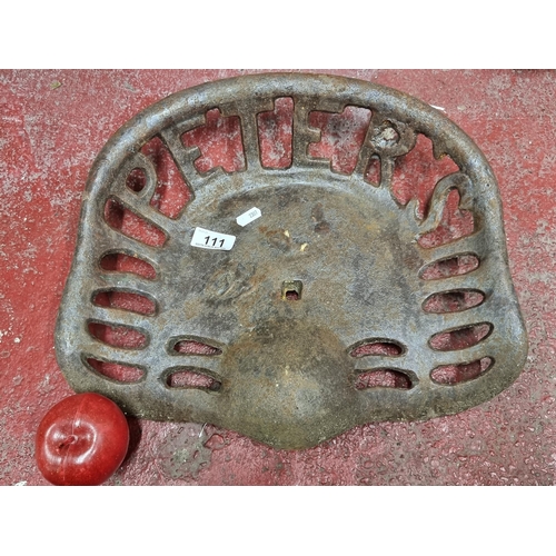 111 - A full size Peter's heavy cast metal tractor seat with pierced detail.