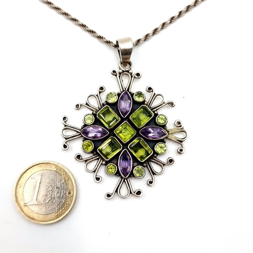 16 - An attractive sterling silver gem set pendant necklace consisting of amethyst and peridot stones wit... 