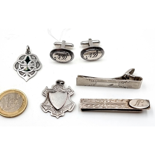 28 - A collection of five items consisting of two sterling silver medallions (weight: 12 grams) together ... 