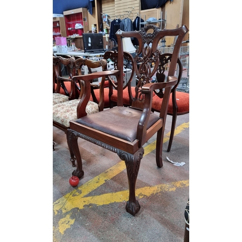 369 - A handsome antique Chippendale style library chair. Supported by large claw and ball feet, knotwork ... 