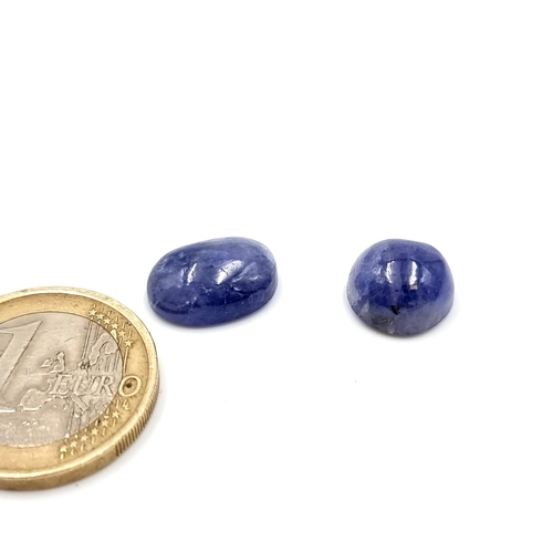 384 - Two natural beautiful tanzanite gemstones including a round cabochon (7.250 carat) with an oval cabo... 