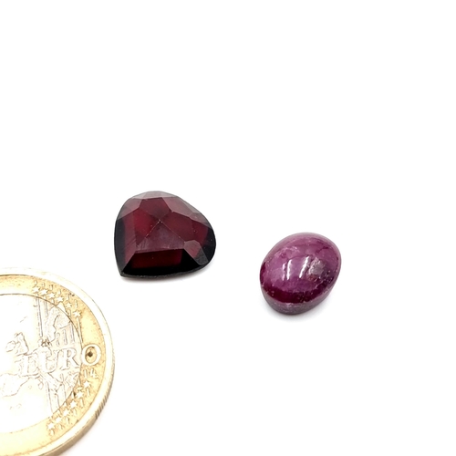 385 - Two natural beautiful gemstones including an oval cabochon star ruby (6.3 carats) with a natural, pe... 