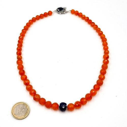 394 - A  fabulous and unusual 240 carat carnelian necklace with blue sapphire gem stone to centre and blue... 