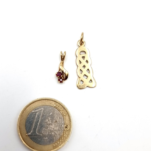 42 - A collection of two 9 carat gold pendants, the first set with a ruby stone, along with a Celtic desi... 