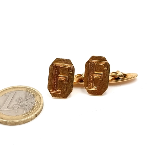 430 - A pair of 18 carat gold cuff links initialled F. 
Total weight: 12.01 grams