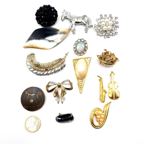 44 - A collection of 14 brooches consisting of jet, ormolu, and gem set examples. All pins in tact.