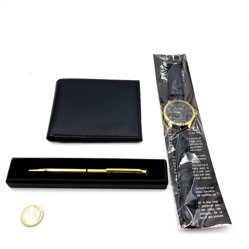 445 - A Swarovski ballpoint pen, together with an Eiger wristwatch and a leather wallet. All in as new con... 