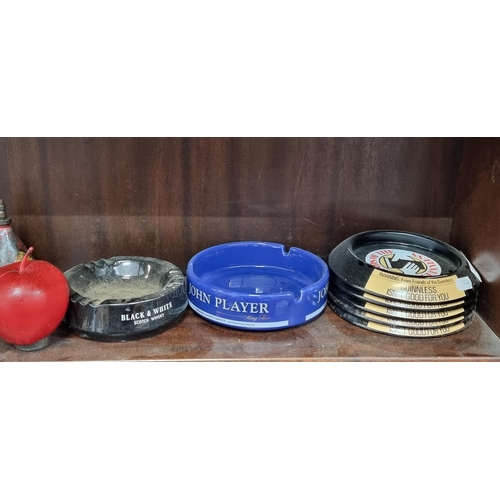 459 - Seven ashtrays including a Black and White scotch whisky ceramic ashtray by Wade, a John Player cera... 