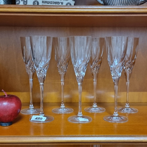 488 - Seven matching champagne flutes with a nice swirl design. In very good condition.