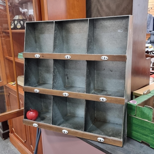 493 - A vintage style galvanized metal pigeonhole unit with nine compartments and ceramic numbers.