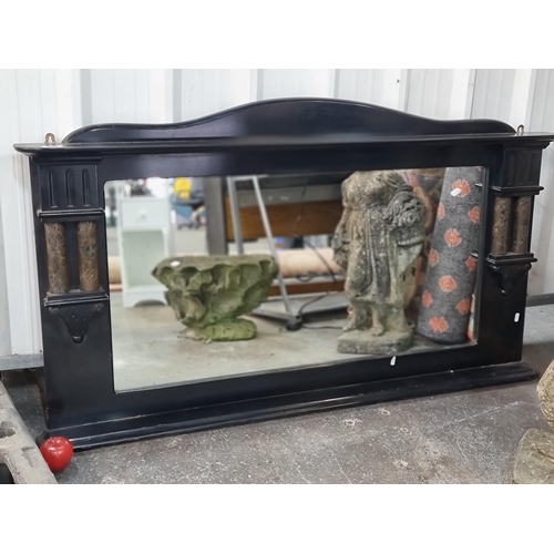 494 - A very large and heavy quality mantle mirror housed in an ebonised wood frame featuring classical ma... 