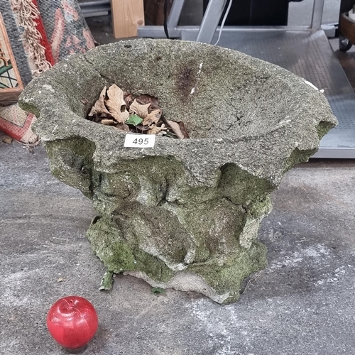 495 - An unusual antique stone garden planter in an organic form. H30cm