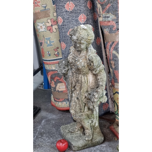 496 - A charming large solid antique reconstituted stone garden figure depicting a young girl carrying bas... 