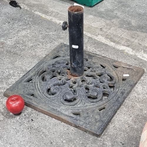 518 - A heavy cast iron parasol stand with pierced foliate detail.