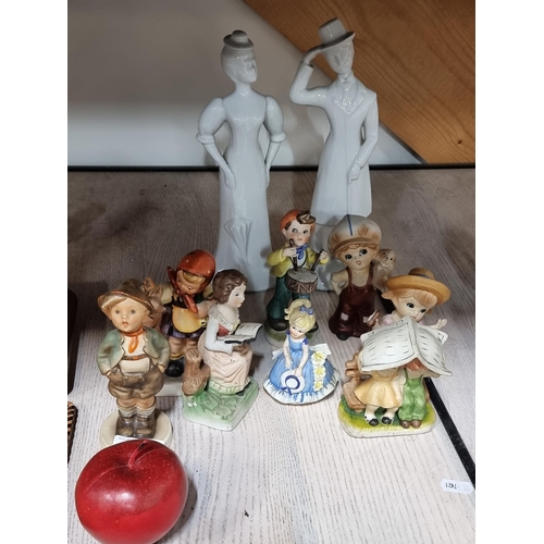 523 - A selection of ceramic figurines including two West German examples by brands Hummel and Friedel in ... 