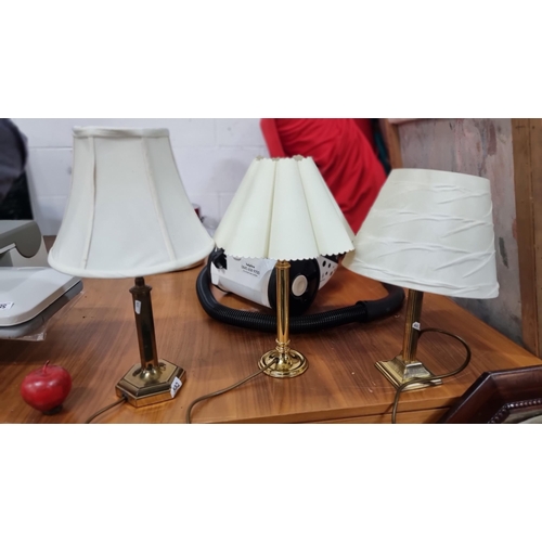 582 - A selection of three good quality  brass vintage table lamps. All with heavy brass bases and cream s... 