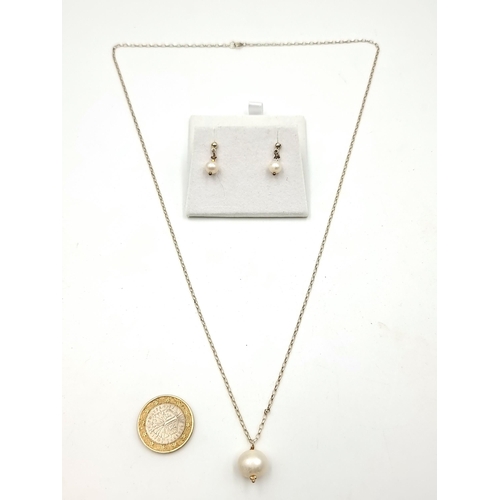 763 - A sterling silver pearl pendant necklace with matching drop stud earrings. 
Length of chain: 46 cm