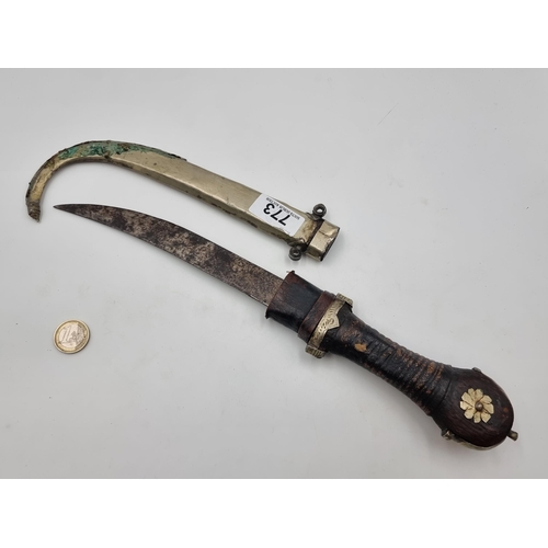 773 - A super vintage Arabian curved dagger set with metal detailing. Accompanied by associated metal shea... 