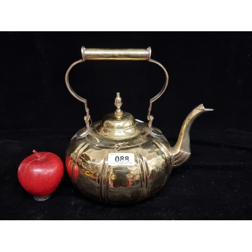 88 - A polished brass tea kettle. A charming vintage style example with a high gloss polish.