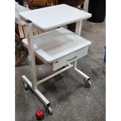 555 - A super portable medical cart by Enraf Nonius Delft. With shelving space and drawer to base. Set on ... 